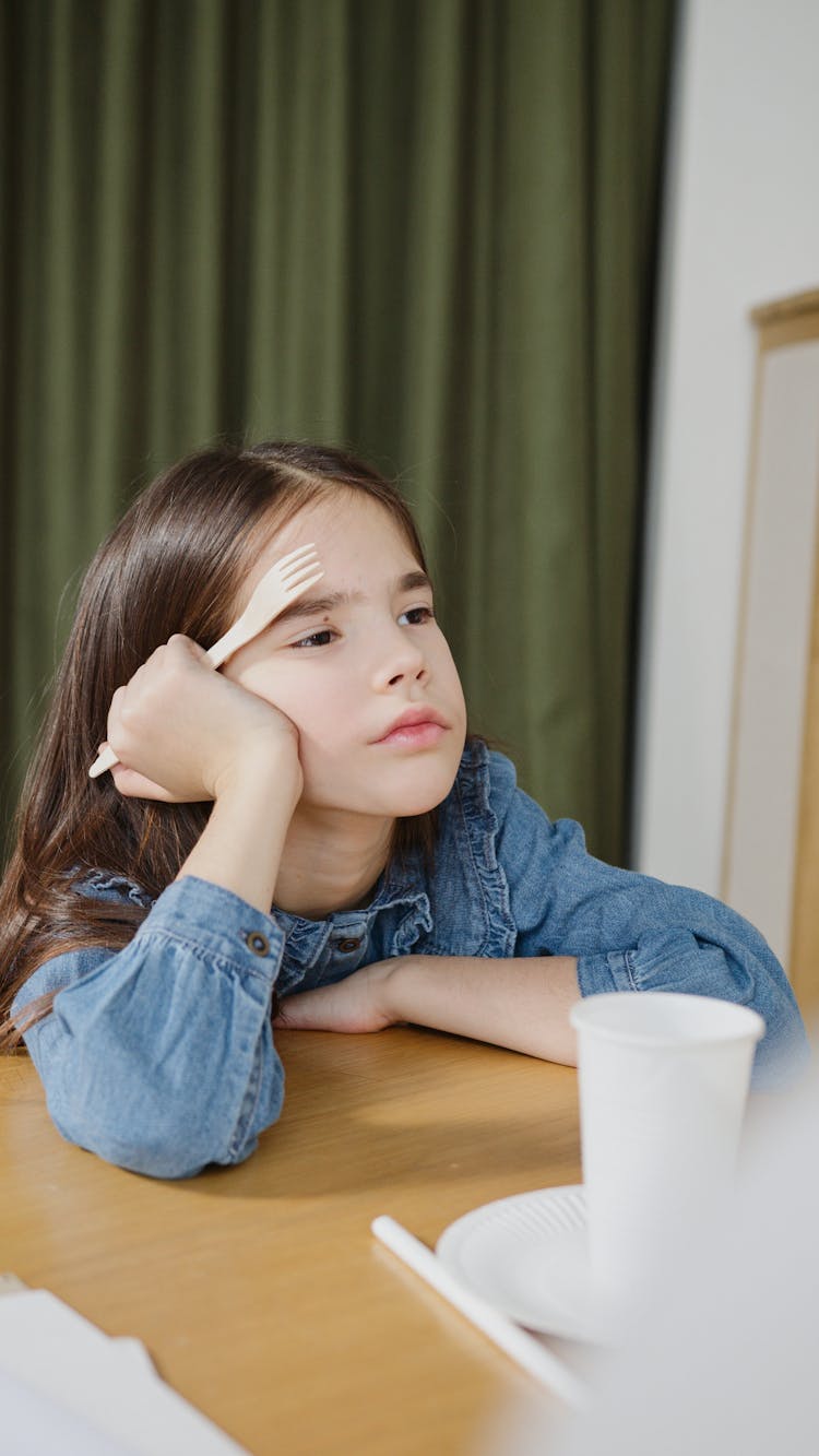 Young Girl Holding A Fork