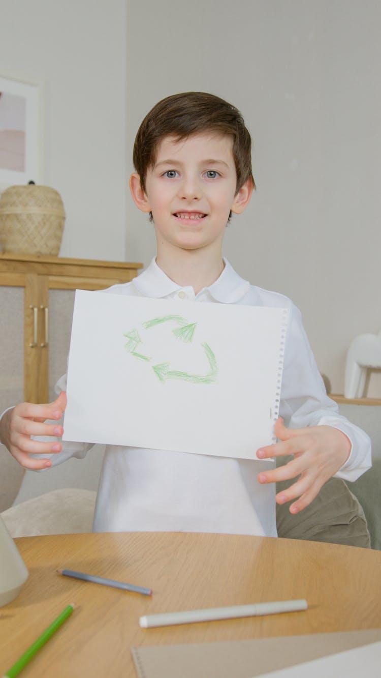 Kid Holding A Drawing On A Paper