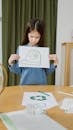 Young Girl Holding Her Drawing