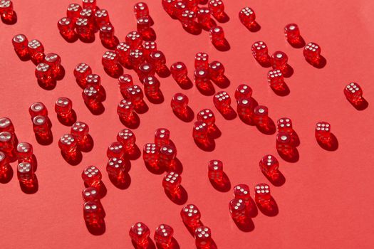 Multiple red dice scattered across a vivid red surface, creating a striking visual composition.