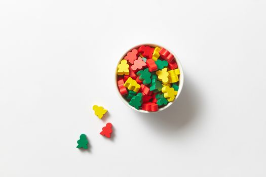 Top view of colorful toy blocks in a bowl on a white background. Perfect for educational themes.