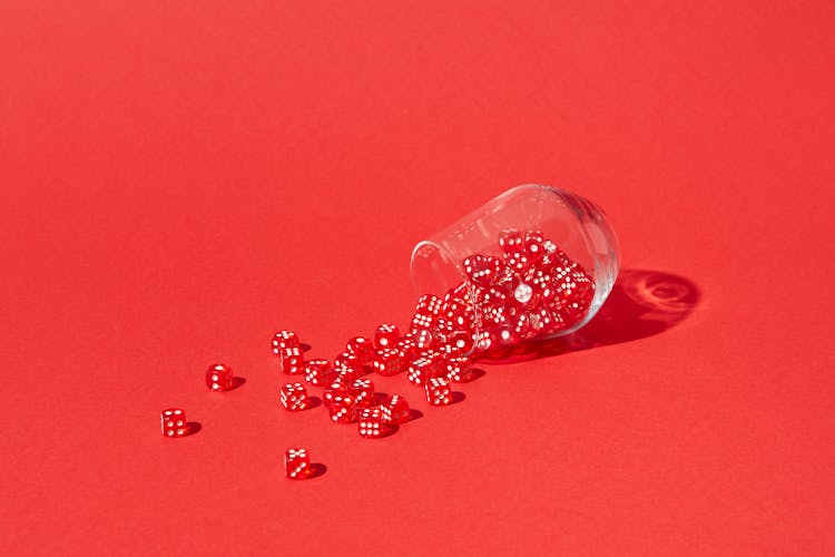 Spilled Red And White Dice From A Glass