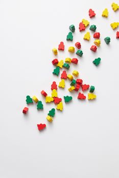 Scattered colorful wooden toy shapes on a white background, perfect for playful themes.