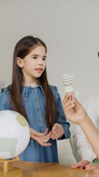 A girl engages in a discussion about energy efficiency at home.