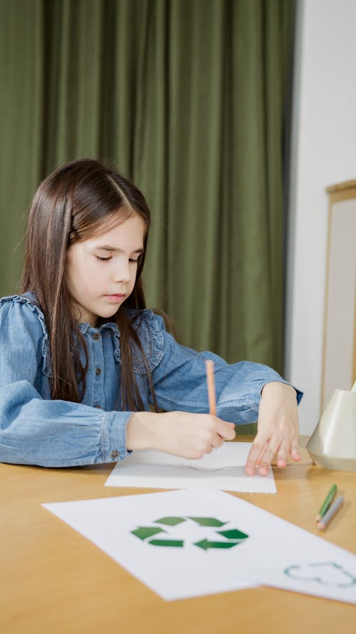 A Girl Drawing On Paper