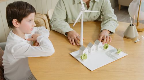 Free A child explores renewable energy models in a classroom setting. Stock Photo