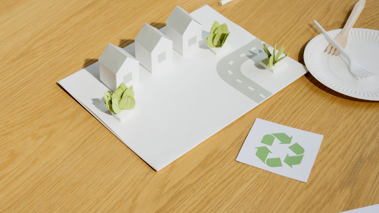 Small white paper model houses on a table, useful for planning the size and layout of a tiny house