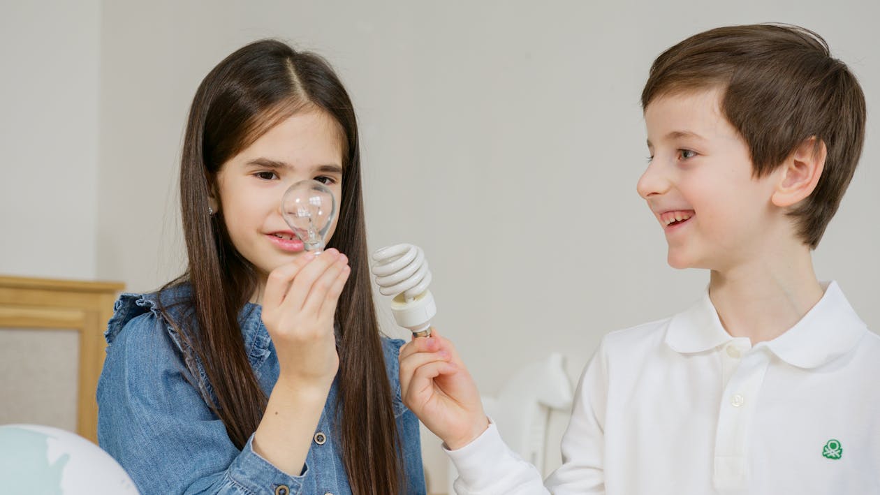 Kids Holding Different Types of Lightbulbs