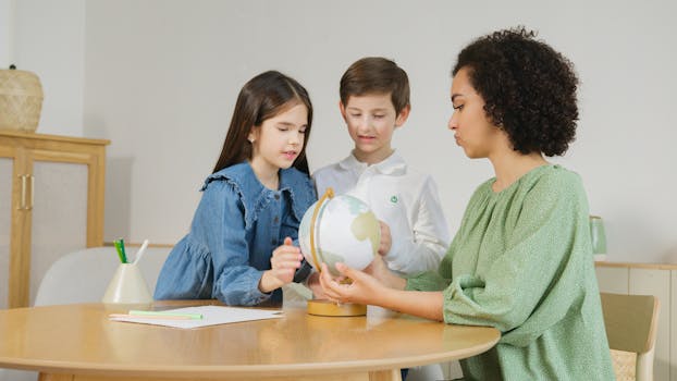 Teacher interacting with two children, exploring a globe indoors.