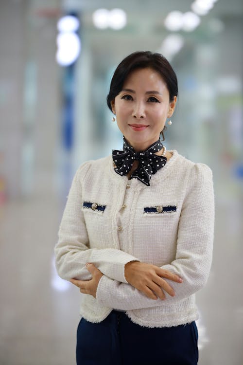 Woman in White Sweater and Black and White Polka Dot Bowtie