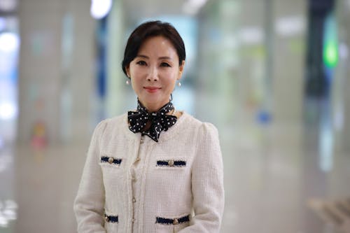 An Elegant Looking Woman with a Black and White Polka Dot Neck Scarf