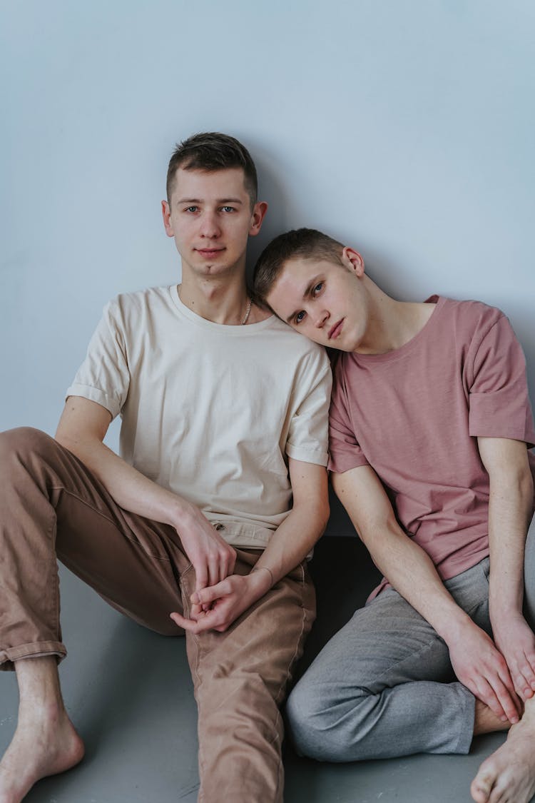 A Couple Sitting Close Together On The Floor