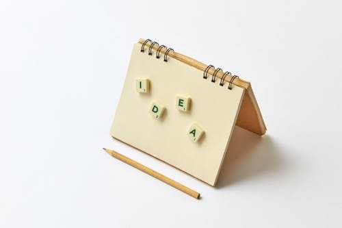 Free A Word Idea Spelled on a Scrabble Tile Stuck on a Notebook Stock Photo