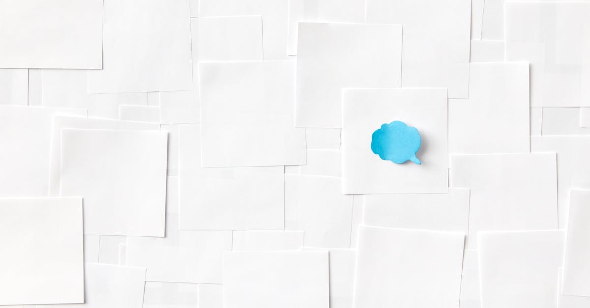 A blue speech bubble on a white paper surface symbolizing communication and ideas.