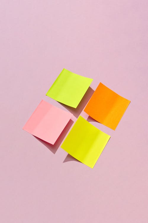 Colorful Sticky Notes on a Pink Surface