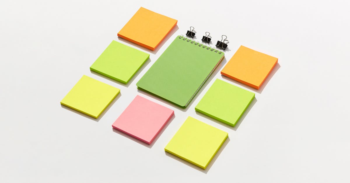 Sticky Notepads and Binder Paper Clips on White Surface · Free Stock Photo