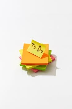 Stack of colorful sticky notes with a 'To Do' note on top, isolated on white.