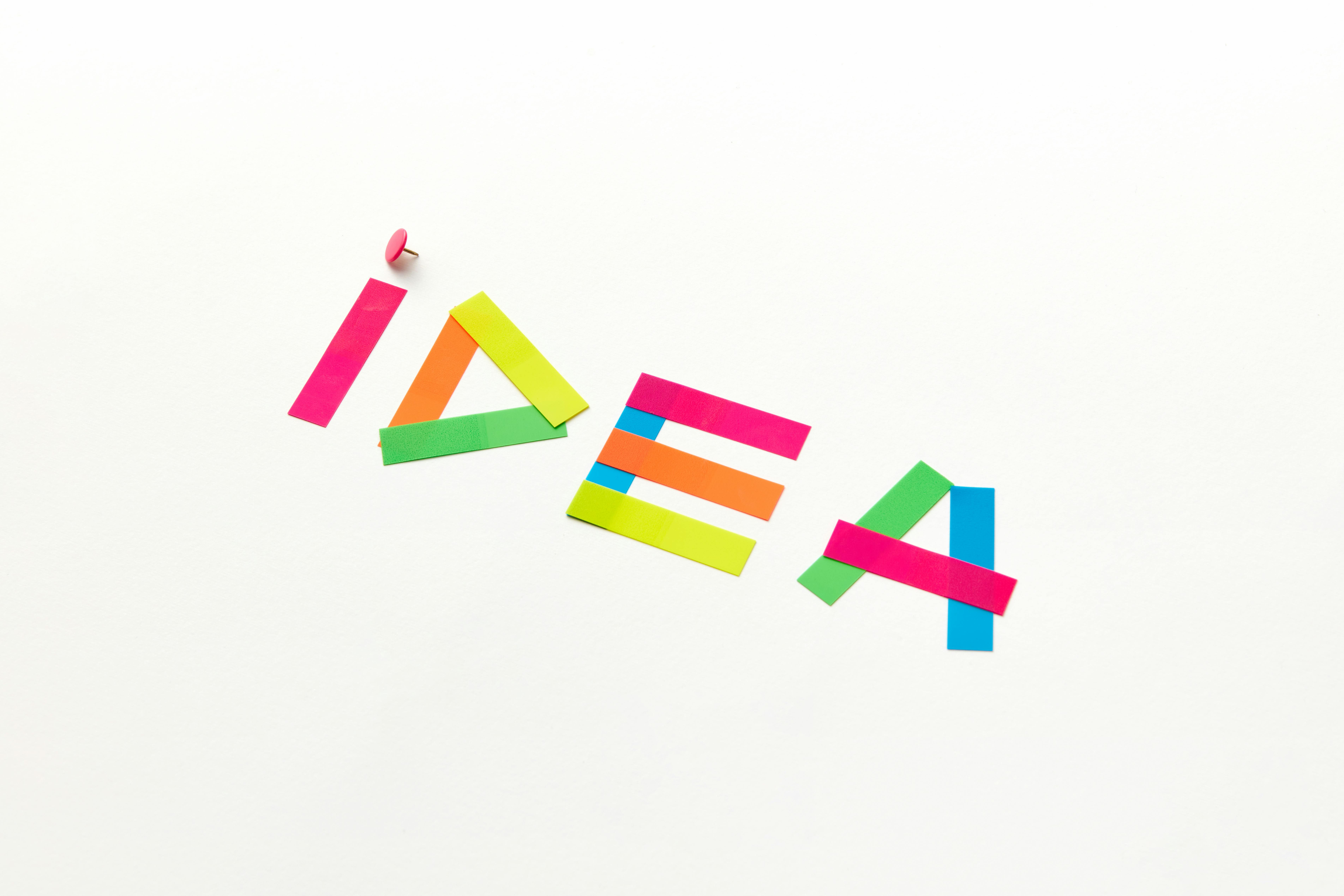 Creative concept with colorful paper cutouts spelling 'IDEA' against a white background.
