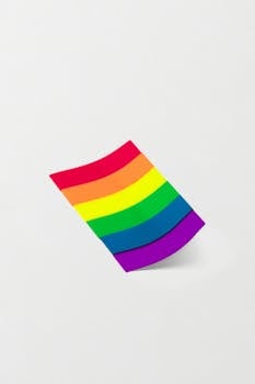 Vibrant rainbow-colored sticky note on a white background, symbolizing diversity and inclusion.