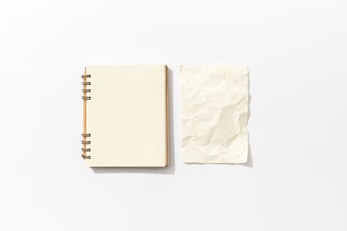 A Blank Notebook and Creased Paper