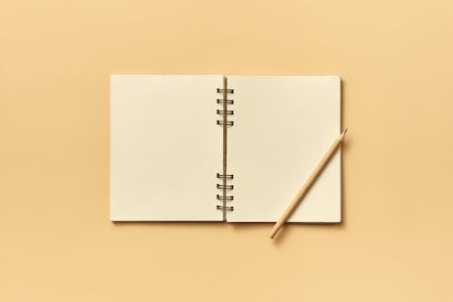 Wooden Pencil on Edge of the Notepad