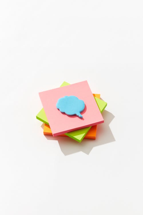 A Speech Bubble Sticky Note Pad on a Stack of Sticky Note Pads