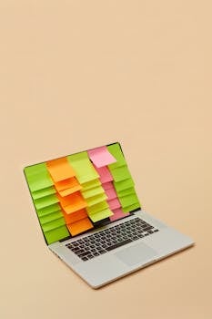 A laptop with multiple sticky notes on the screen, showcasing organization and productivity.