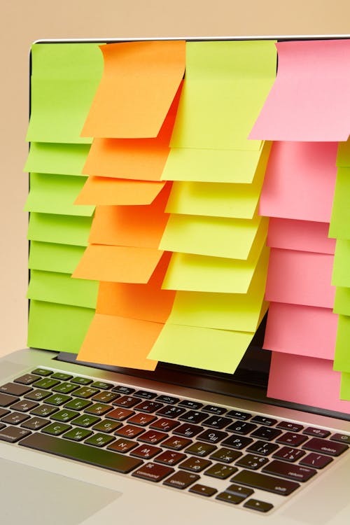 Free Close-Up Shot of a Laptop with Sticky Notes Stock Photo