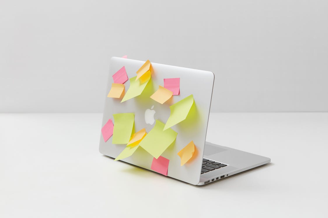 Yellow Green and Pink Sticky Notes on Silver Laptop · Free Stock Photo