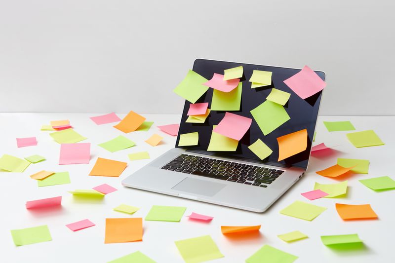 desk calendar with sticky notes layered over certain dates