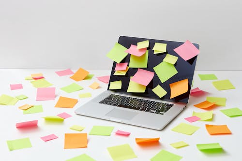 A Laptop with Multicolor Sticky Notes