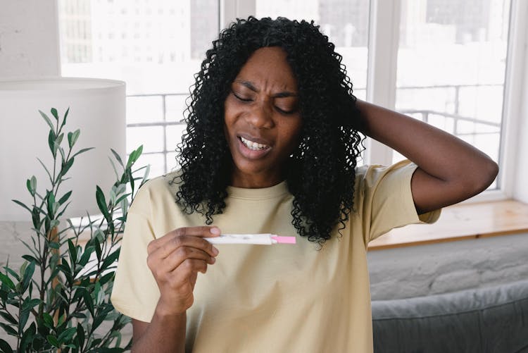 Upset Black Woman With Pregnancy Test