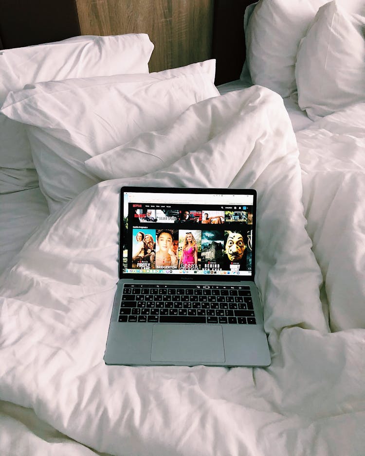 Laptop With Movie Website On Cozy Bed