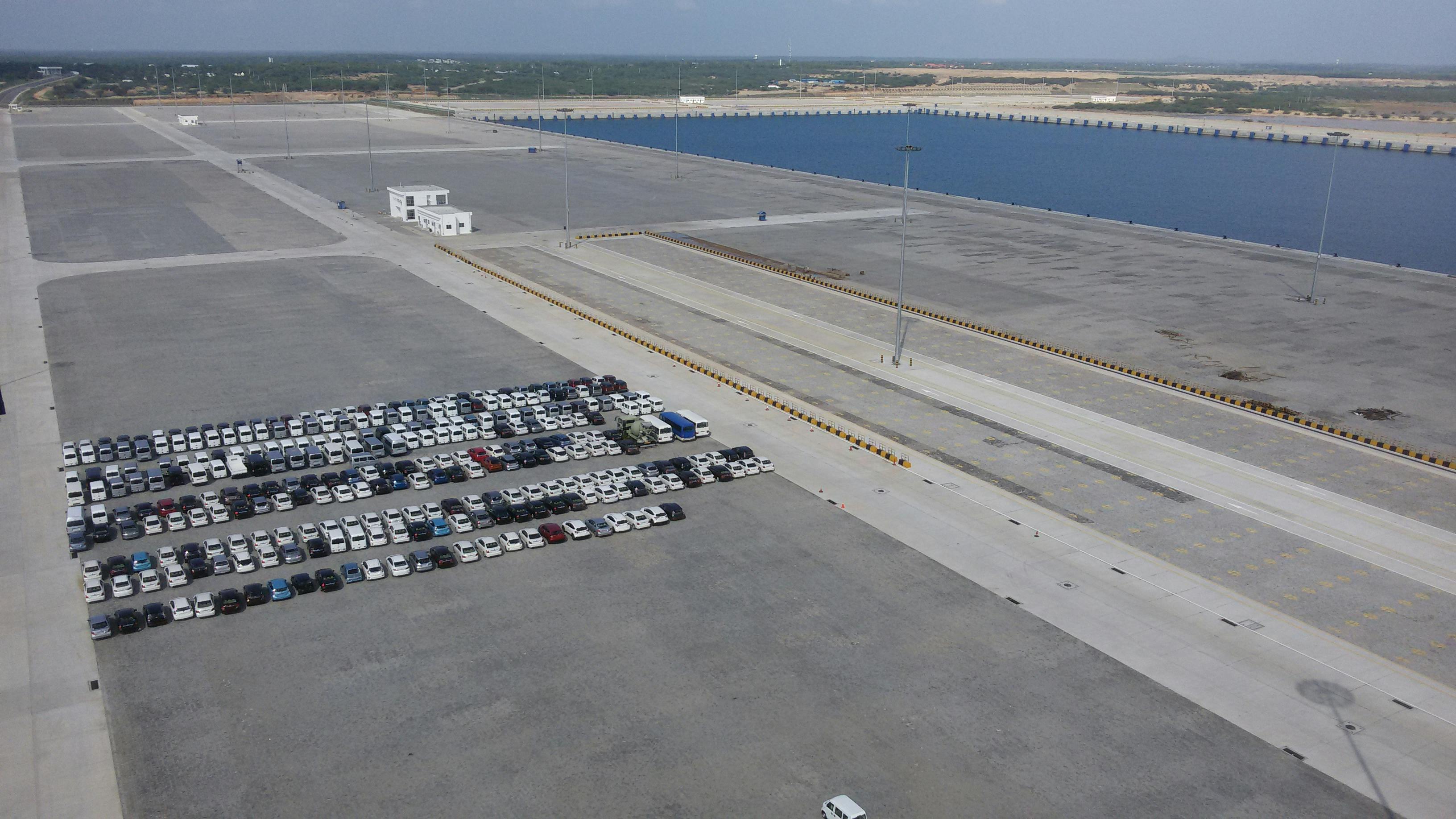 Person studying at desk with headphones and laptop, listening to background music