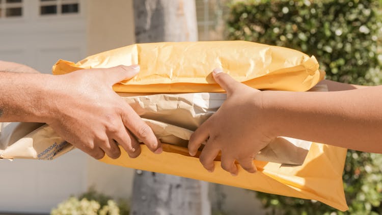 A Person Handing Over Delivery Packages