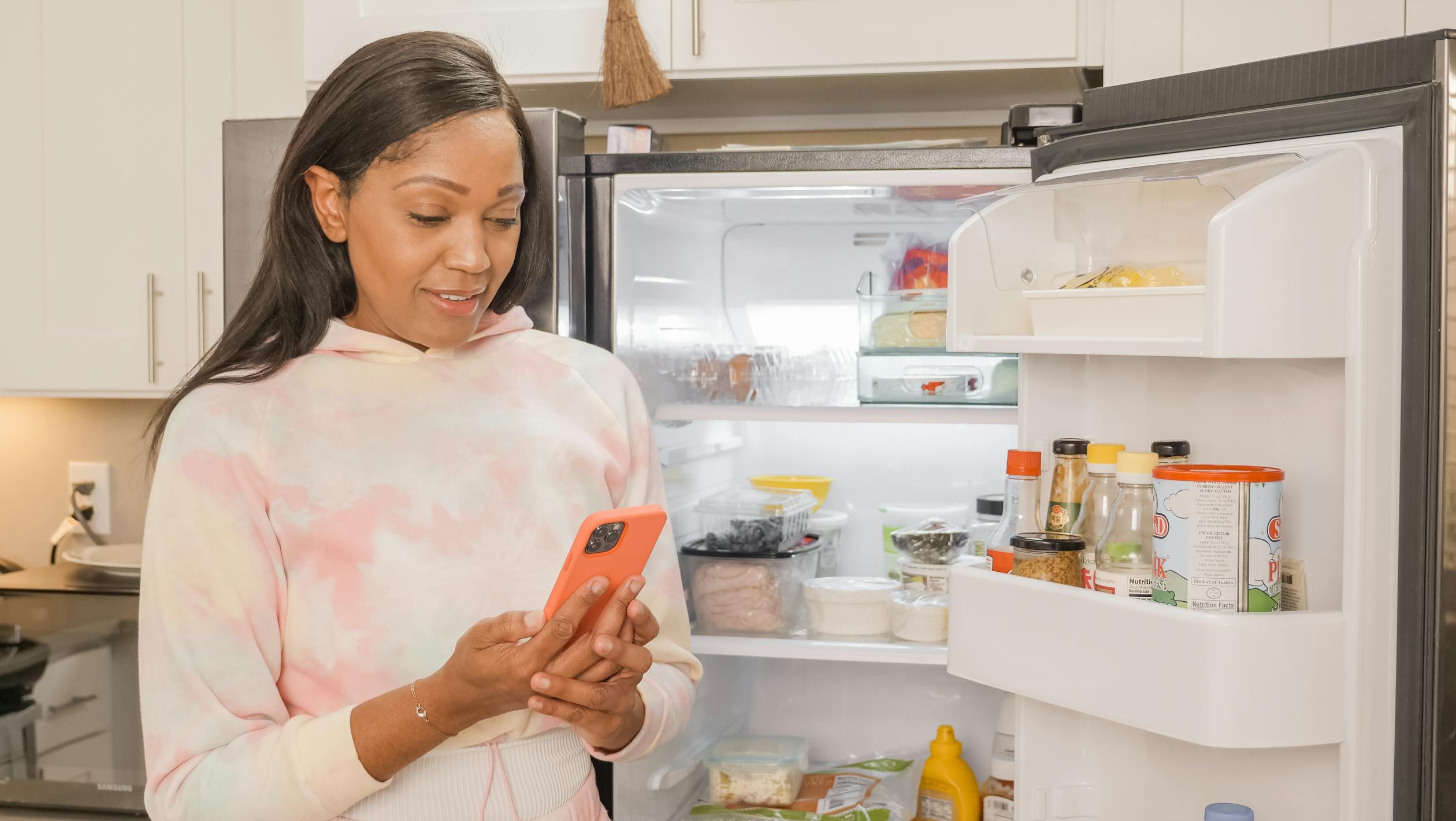 woman standing in front of fridge