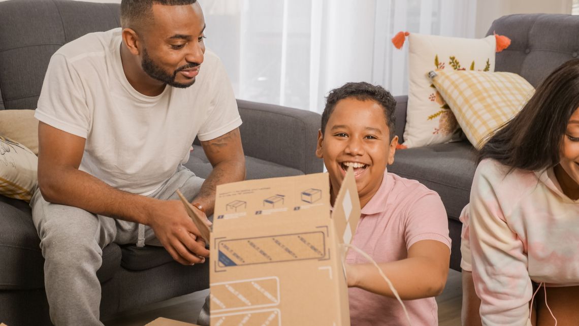 Family together at home opening and reviewing delivered packages
