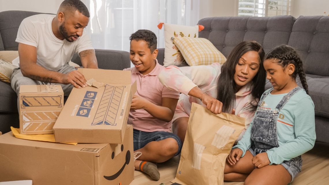 Family happily opening delivered packages together at home
