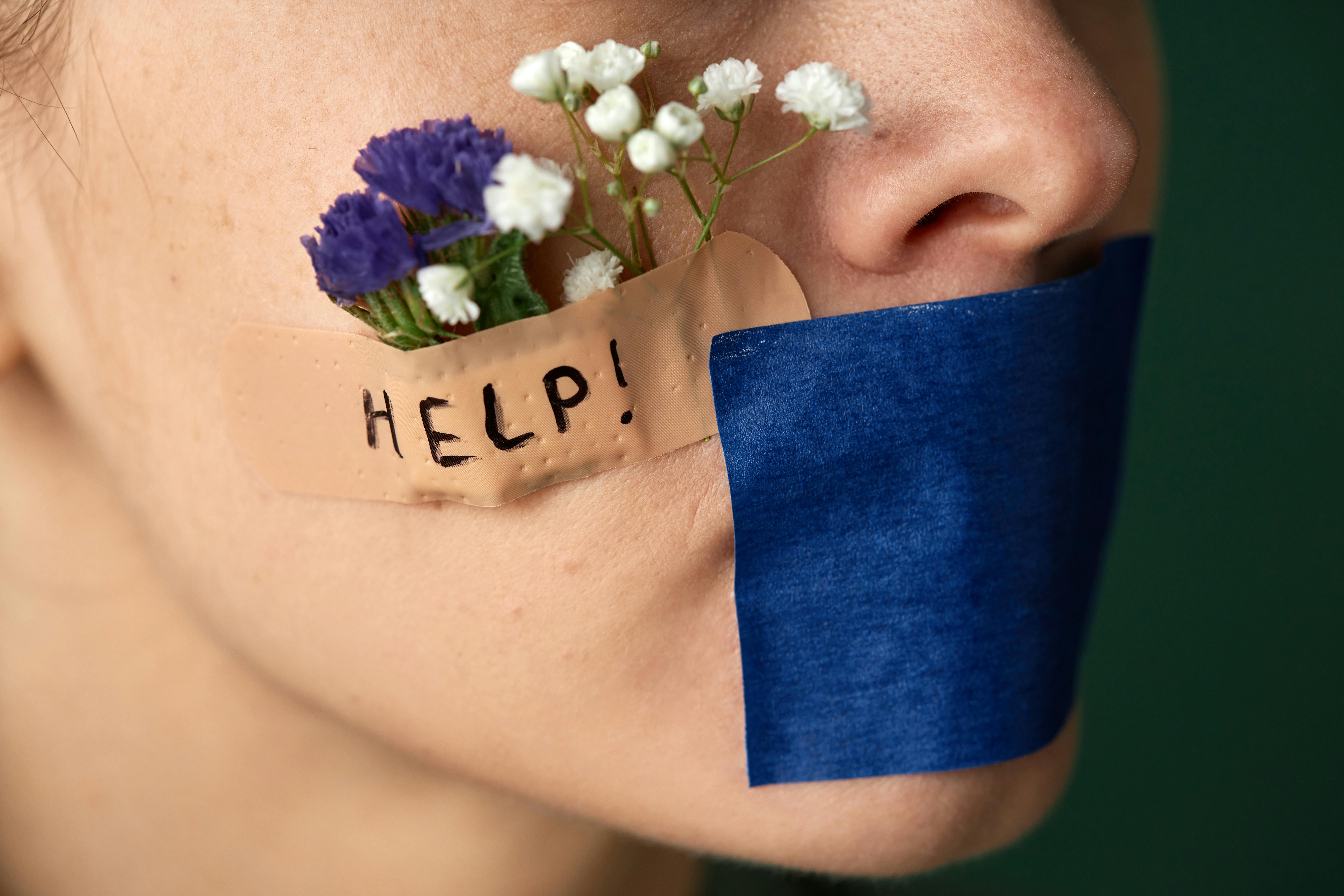 close up of a face with a tape over the mouth