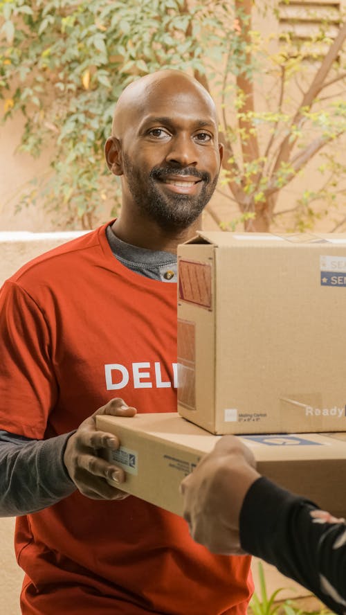 Bearded Man in Orange Shirt Delivering Parcels