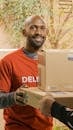 Bearded Man in Orange Shirt Delivering Parcels
