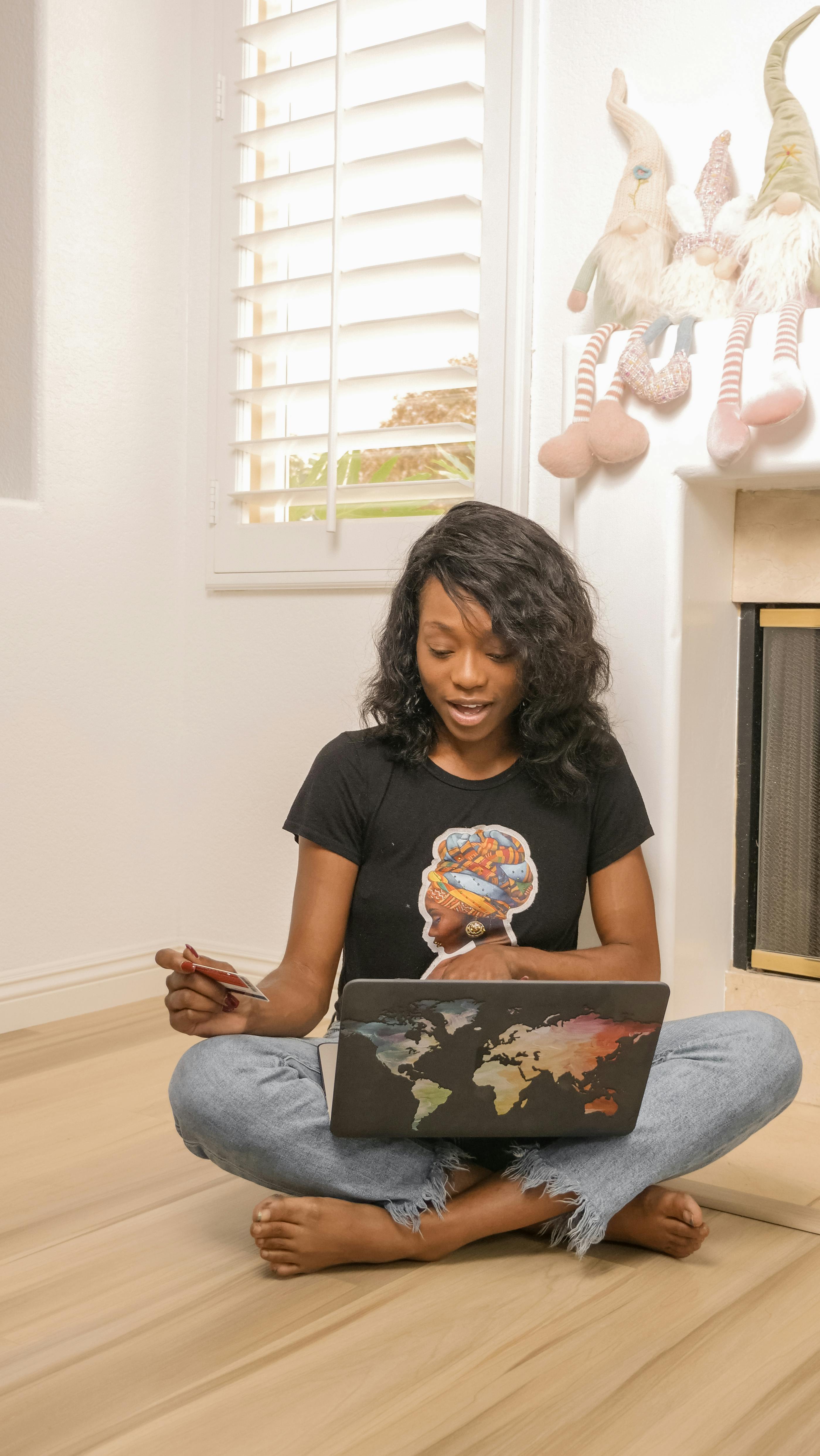 a woman sitting on floor shopping online