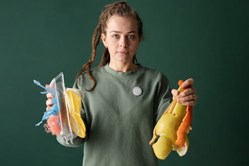 Free Woman Holding Plastic and Organic Trash in Hands Stock Photo