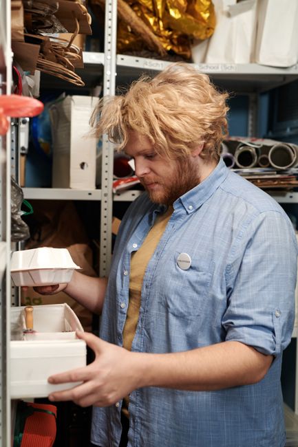 person organizing shelves boxes