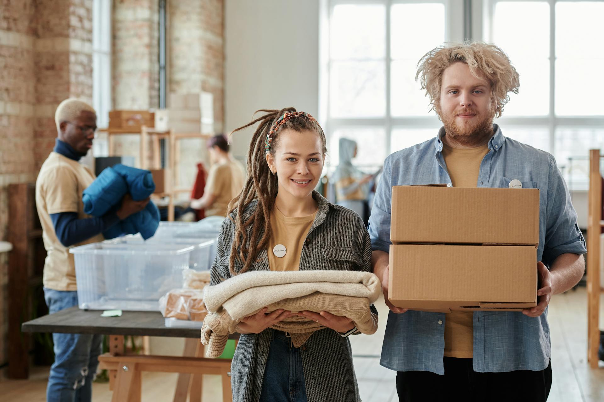 A Man and a Woman Holding Donations