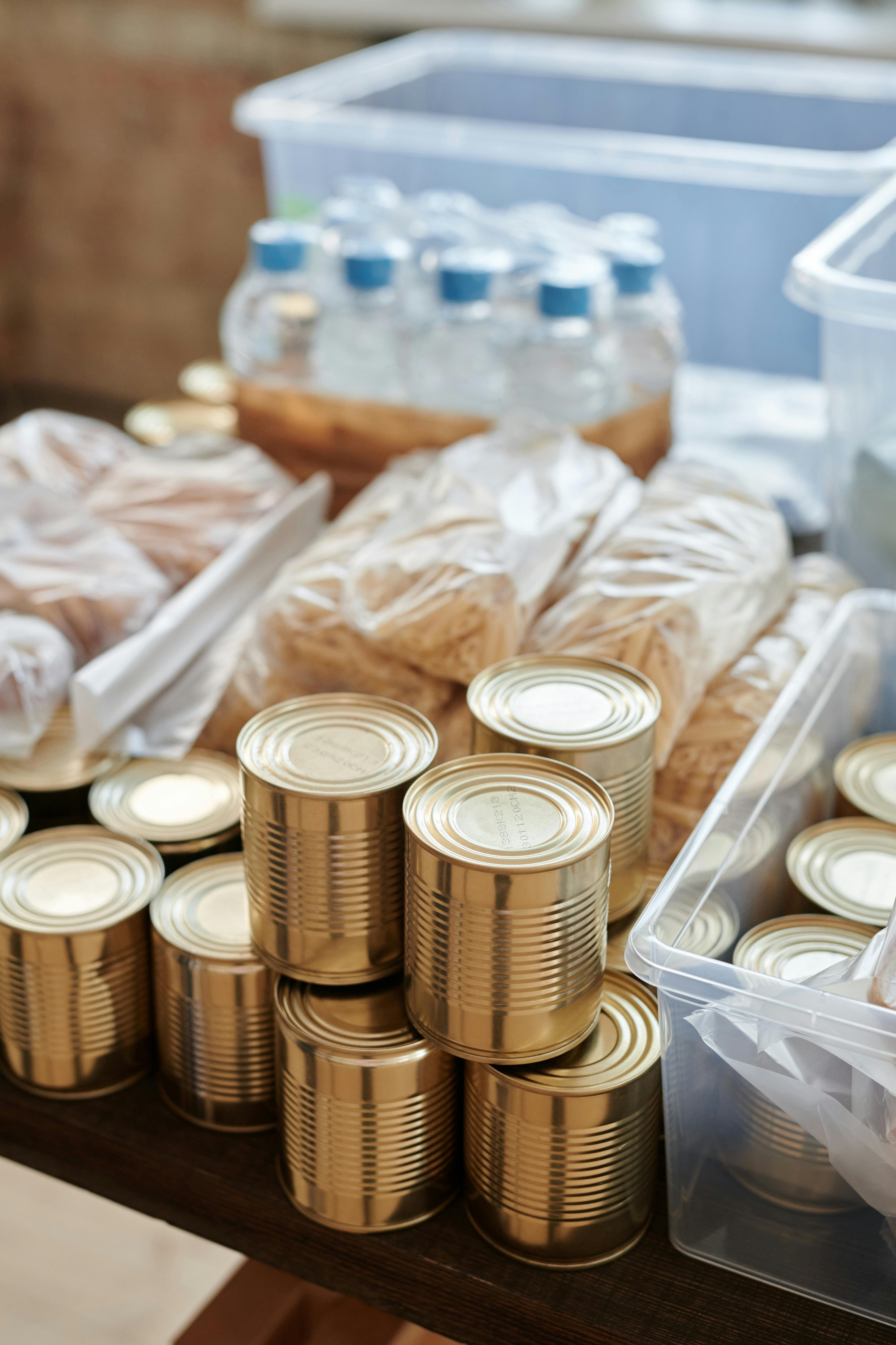 An image of food cans, water bottles and other packaged food for donation at a food bank