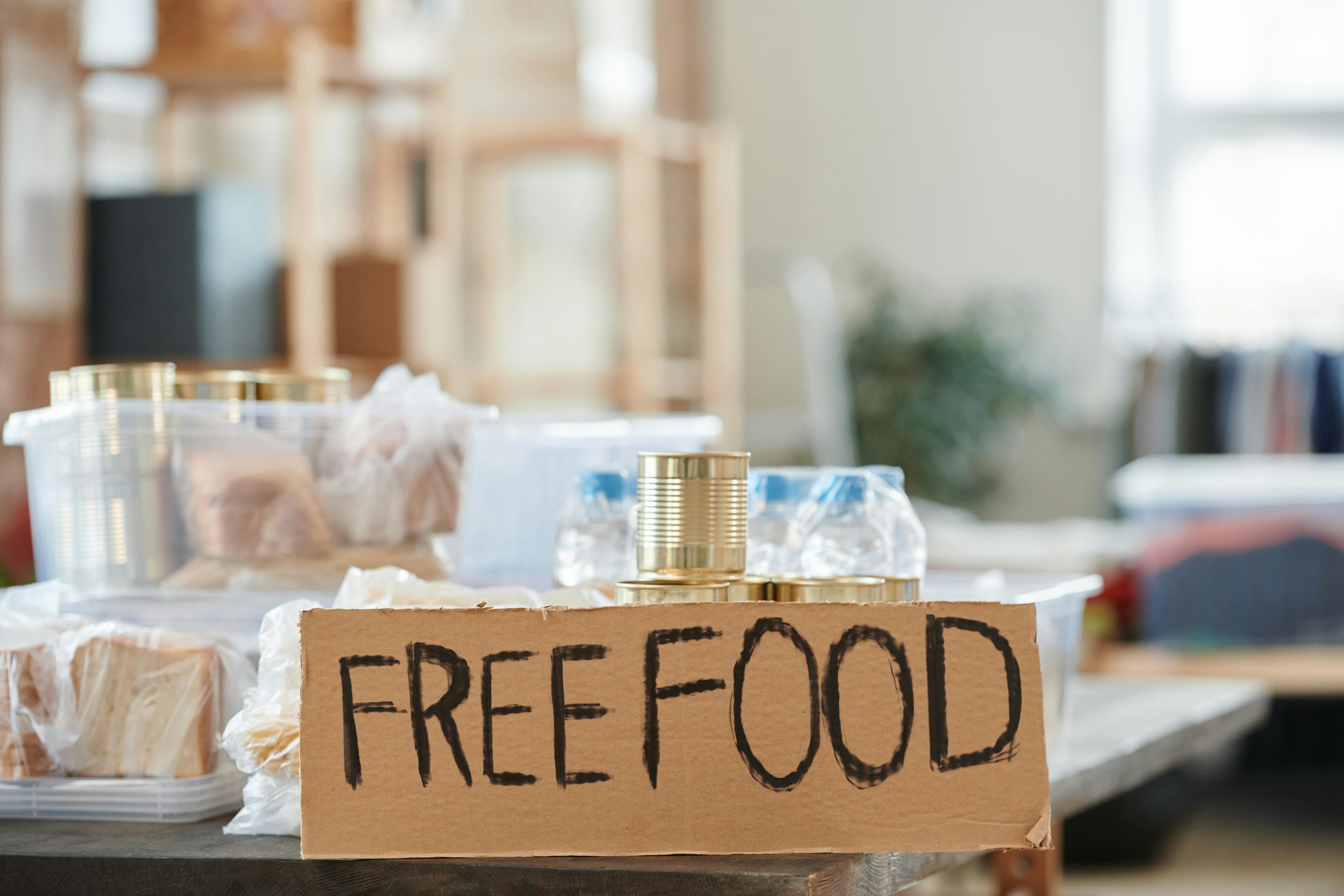 Indoor view of a donation table with free food and canned goods.