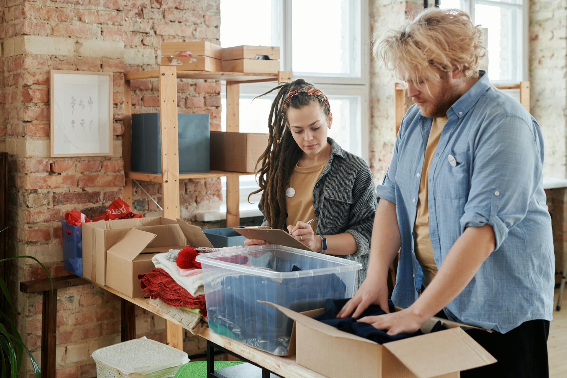 People Packing Donations in Boxes