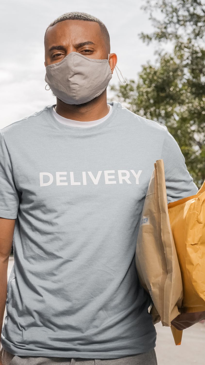 Delivery driver holding packages