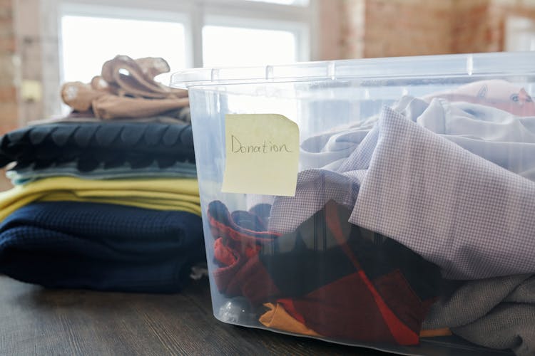 
Clothes In A Plastic Box For Donation